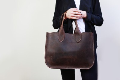 16 inches wide x 11 3/4 inches high x 2 inches deep. Strap drop is approximately 8 inches.