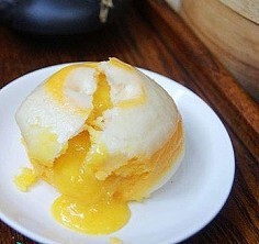 流沙包（中） 1.面粉、酵母、泡打粉加牛奶揉成光滑的面团，饧15分钟； 2.咸蛋黄蒸熟，用刀背碾碎，加糖、牛奶少许、黄油混合调匀，成馅儿； 3.把面团搓成长条状，分成10等份，用手压扁； 4.将馅料放面皮中间，捏紧收…
